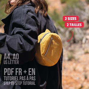 May include: A mustard yellow corduroy backpack with a rounded shape and a front zipper pocket. Text on the image reads: 2 SIZES, 2 TAILLES, A4, A0, US LETTER, PDF FR + EN, TUTORIEL PAS À PAS, STEP BY STEP TUTORIAL. The bag is worn over a black jacket.