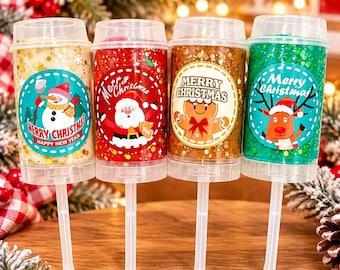 May include: Four clear plastic push-pop containers filled with colorful glittery slime. Each features a circular label with holiday characters: a snowman, Santa Claus, a gingerbread person, and a reindeer, all with Merry Christmas text.