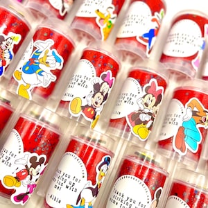 May include: Red and white confetti filled party poppers with Disney character stickers. The stickers feature Mickey Mouse, Minnie Mouse, Donald Duck, and Goofy. The stickers have the text "Thank you for striking up some fun with me! - Albie".