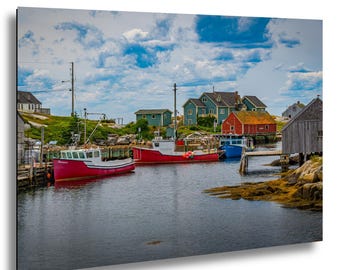 May include: A scenic coastal print featuring a harbor with several colorful fishing boats. The boats are red, white, and blue, docked near wooden buildings and houses. The sky is blue with fluffy white clouds, creating a picturesque maritime scene.