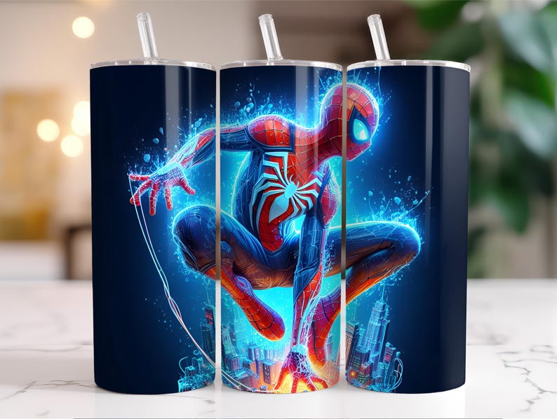 May include: A set of three stainless steel tumblers with straws, each featuring a vibrant illustration of Spider-Man in a dynamic pose. The design showcases the superhero with red, blue, and white colors, set against a dark blue background with cityscapes.