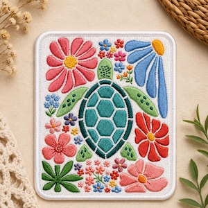 May include: Embroidered patch featuring a teal sea turtle surrounded by colorful flowers. The flowers include pink, red, blue, and purple blooms with green leaves. The patch is on a white background with a white border.