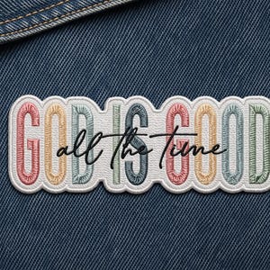 May include: Embroidered patch with the words "GOD IS GOOD all the time" in colorful letters. The patch has a white border and is set against a denim background.