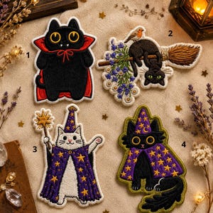 May include: A collection of embroidered patches depicting black cats in Halloween-themed outfits. Designs include a vampire cat, a cat on a broom with a bird, and wizard cats with star-patterned capes. Each patch has a white border.