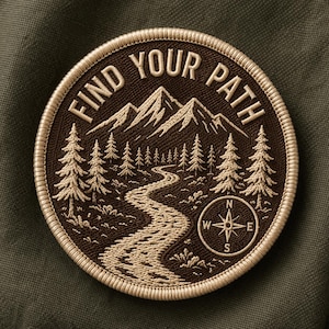 May include: Embroidered patch with the text "FIND YOUR PATH" around a mountain and forest scene. The patch features a winding river, pine trees, and a compass rose in shades of brown and beige.