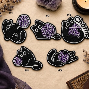 May include: Set of five black cat patches with white outlines, each featuring a purple and white D20 die. One patch has the word "Chomp". These patches are perfect for gamers and cat lovers.