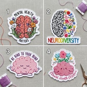 May include: Four embroidered patches with mental health themes. One shows a brain with flowers and the text "Mental Health Matters." Another says "Neurodiversity." The third says "Be Kind to Your Mind." The last says "Mental Health Matters."