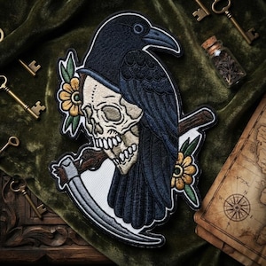 May include: An embroidered patch featuring a black raven perched atop a beige human skull. The design includes a silver scythe blade held by the skull and two yellow flowers with green leaves. The embroidery uses black, white, yellow, and green thread.