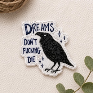 May include: A set of three ceramic mugs with a speckled, matte finish. The mugs are in shades of cream, light gray, and dark gray. Each mug has a simple, minimalist design and a rounded handle.