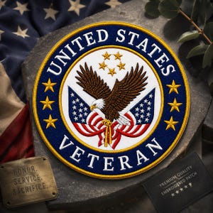 May include: Embroidered patch with the words "UNITED STATES VETERAN" in white on a navy blue background. The patch features a detailed eagle, flags, and stars. The patch is round and has a gold border. The patch also has the words "HONOR. SERVICE. SACRIFICE."