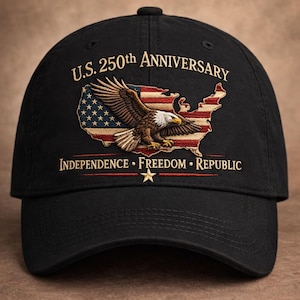 May include: Black baseball cap featuring an embroidered design commemorating the U.S. 250th Anniversary. The design includes an American flag, an eagle, and the words "Independence, Freedom, Republic."