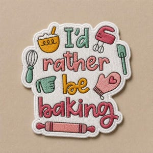 May include: Embroidered patch with the phrase "I'd rather be baking" in a whimsical font. The patch features illustrations of baking tools like a whisk, mixer, and rolling pin, in shades of green, pink, and yellow.