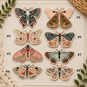 May include: A collection of eight embroidered moth patches. Each patch features a unique design with various colors, including pink, green, orange, and brown. The patches are numbered from #1 to #8.