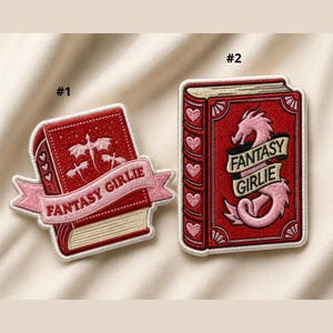 May include: Two embroidered patches with a fantasy theme. One patch features a red book with a pink banner that reads "FANTASY GIRLIE" and a dragon design. The other patch has a similar design with a dragon and the same text.