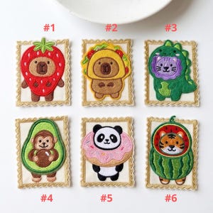 May include: Embroidered patches featuring cute animal characters in food costumes. Includes a strawberry bear, taco bear, dinosaur lion, avocado monkey, panda donut, and watermelon tiger. Each patch is framed with a decorative border and numbered.