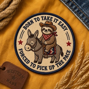 May include: A circular embroidered patch featuring a brown sloth wearing a cowboy hat and red bandana, riding a grey donkey. The text BORN TO TAKE IT EASY FORCED TO PICK UP THE PACE is stitched in dark blue around the border with two red stars.