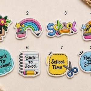 May include: A collection of eight embroidered iron-on patches featuring school-themed designs. The patches include illustrations of a chalkboard, rainbows with pencils, notebooks, apples, scissors, and backpacks, all with the text Back to School or School Time.