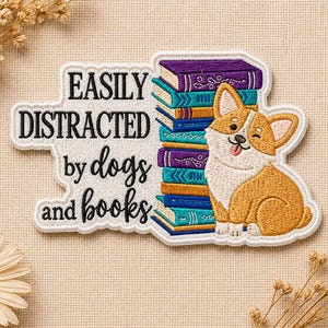 May include: Embroidered patch with the text "EASILY DISTRACTED by dogs and books." Features a stack of books and a winking corgi dog. The books are purple, teal, and gold. The corgi is orange, white, and tan.