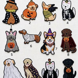 May include: A collection of twelve embroidered iron-on patches featuring various dog breeds dressed in Halloween costumes, including a wizard, a pumpkin, a bat, a skeleton, a mummy, and a ghost, each numbered from one to twelve for identification.