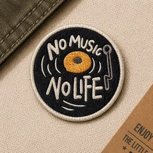 May include: A round, black embroidered patch with the words "NO MUSIC NO LIFE" in white. The patch features a yellow and orange record design with a gray needle. The patch is on a beige fabric background.