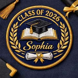May include: A navy blue embroidered patch with gold accents, featuring the text "CLASS OF 2026" and the name "Sophia." The design includes a graduation cap, an open book, and a scroll. A gold tassel and laurel wreath complete the design.