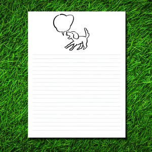 May include: White lined paper with a black line drawing of a dog with a speech bubble. The dog is jumping and appears to be barking. The paper is set against a background of green grass.