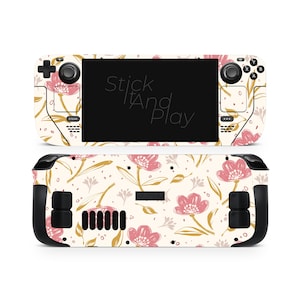 Peut inclure: Une peau à motifs floraux pour une console de jeu portable. La peau présente un fond crème avec des illustrations de fleurs roses et dorées. Le texte "Stick It And Play" est visible sur l'écran.