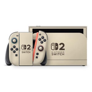 May include: A beige Nintendo Switch console with matching Joy-Con controllers. The controllers have black buttons and a coral-colored side. The console and controllers feature the Nintendo Switch logo and the number "2".