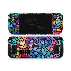Peut inclure: Un skin pour console Steam Deck avec un motif de vitrail coloré. Le design présente une mosaïque de couleurs vives, notamment le bleu, le vert, le jaune et le violet. Le texte "Stick It And Play" est visible sur l'écran.