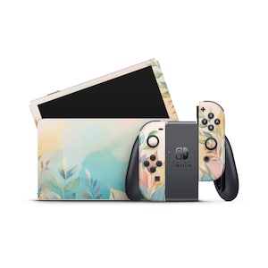 Puede incluir: Una consola Nintendo Switch y mandos con un diseño floral. La consola y los mandos presentan un fondo de acuarela pastel con hojas verdes, rosas y amarillas. La consola Switch es negra y gris.