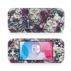 May include: A Nintendo Switch Lite console with a custom skin featuring a Japanese-inspired design. The skin showcases white fox masks, red floral accents, and intricate black patterns. The screen displays the Nintendo Switch logo.