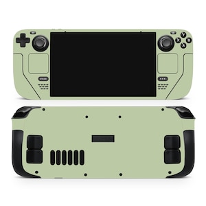 Peut inclure: Console de jeu portable vert clair, vue de face et de dos. L'avant présente un écran noir, des boutons de commande et le logo Steam. L'arrière a des poignées noires et le logo Valve. Conçu pour le jeu portable.
