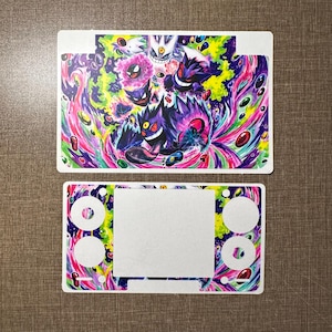 May include: A set of two adhesive vinyl console skins featuring a vibrant, multi-coloured graphic illustration of Gengar and other ghost-type creatures. The design includes swirling patterns of purple, pink, green, and yellow with circular cutouts.
