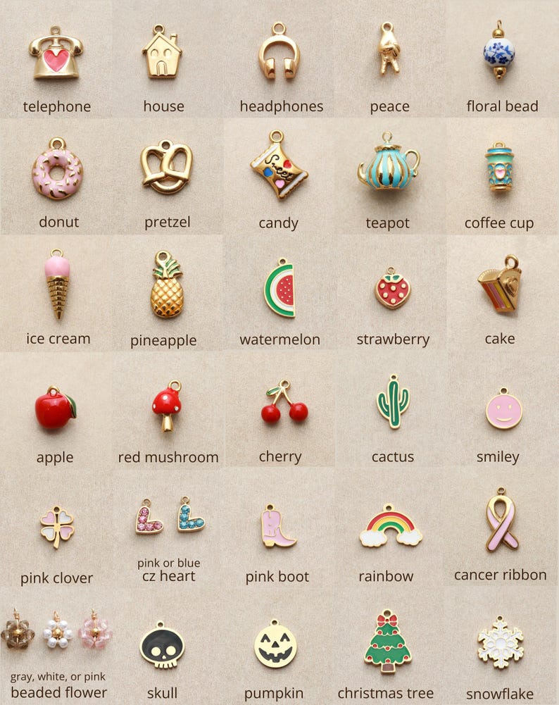 May include: A collection of gold-toned charms in various shapes, including a telephone, house, headphones, peace symbol, floral bead, donut, pretzel, candy, teapot, and coffee cup. Other charms include an ice cream cone, pineapple, watermelon, strawberry, cake, apple, red mushroom, cherry, cactus, and smiley face.