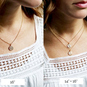 May include: Two gold necklaces with coin pendants. The necklace on the left is 16 inches long and the necklace on the right is 14 inches long with a 16 inch extender.