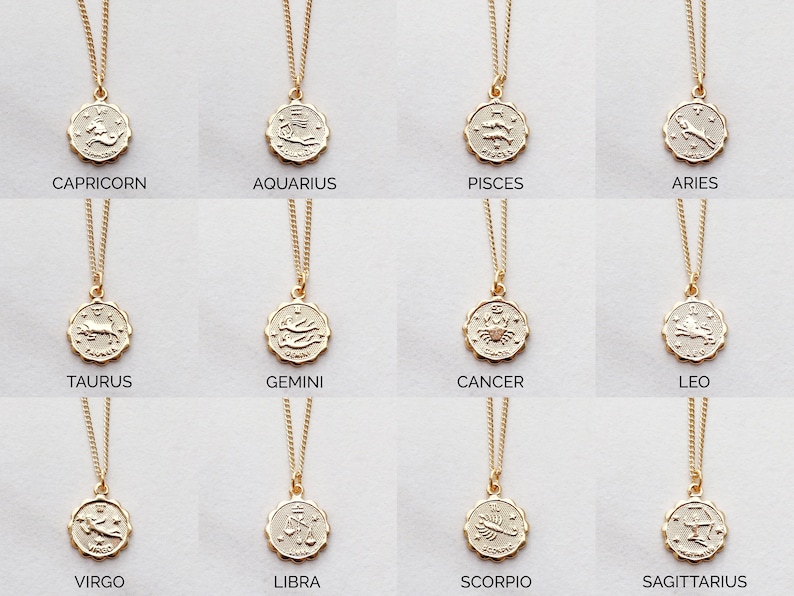 May include: Twelve gold necklaces with zodiac signs as pendants. The signs are: Capricorn, Aquarius, Pisces, Aries, Taurus, Gemini, Cancer, Leo, Virgo, Libra, Scorpio, and Sagittarius.