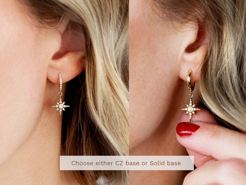 May include: Two gold earrings with a star-shaped charm. The earrings are shown on a model's ear. Choose either CZ base or Solid base.