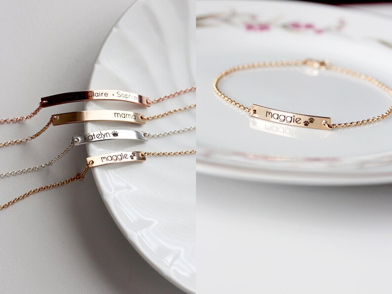 May include: Four gold, silver, and rose gold bracelets with personalized nameplates. The nameplates are engraved with the names "Maggie", "Katelyn", "mama", and "Claire - Sophia".