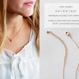 May include: A gold chain necklace with a small letter pendant. The necklace is shown on a model wearing a white shirt. The chain lengths are 14-16 inches, 16-18 inches, and 18-20 inches. Necklaces include a 2 inch extender. The model is wearing the 14-16 inch chain connected mid-way.