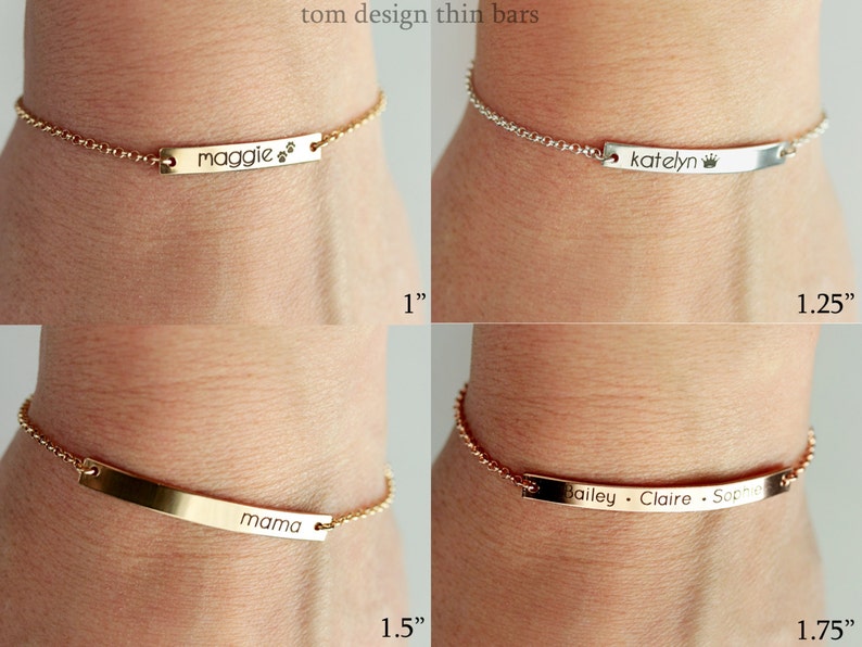 May include: Four gold and silver chain bracelets with personalized engraved bars. The bars are 1 inch, 1.25 inches, 1.5 inches, and 1.75 inches long. The bars are engraved with the names "Maggie", "Katelyn", "Mama", and "Bailey Claire Sophie".