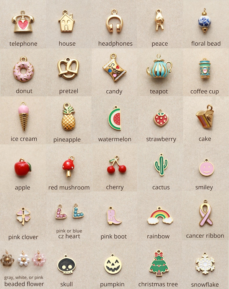 May include: A collection of gold-toned charms in various shapes, including a telephone, house, headphones, peace symbol, floral bead, donut, pretzel, candy, teapot, and coffee cup. Other charms include an ice cream cone, pineapple, watermelon, strawberry, cake, apple, red mushroom, cherry, cactus, and smiley face.