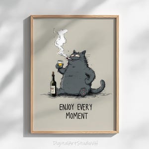 May include: A framed print featuring a cartoon cat smoking a cigarette and holding a glass of amber liquid. A wine bottle sits beside the cat. The text "ENJOY EVERY MOMENT" is below the cat. The print is in a wooden frame.