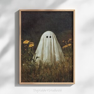 Può includere: Stampa artistica incorniciata con una figura di fantasma drappeggiata in tessuto bianco con due fori neri per gli occhi. Il fantasma si trova in un campo di erba alta e fiori gialli. L'opera d'arte ha un'estetica vintage. Il testo "DigitalArtStudioVH" è in basso.
