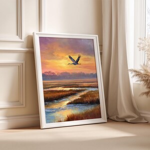 Sandhill Crane soaring digital print for nature-themed spaces — serene painting with warm sunset colors over reflective water.