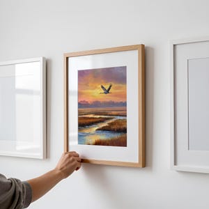 Sandhill Crane artwork for living room — serene flying bird against a painterly sunset with gentle coastal colors and peaceful atmosphere.