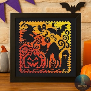 May include: A framed cross-stitch featuring a Halloween scene. The design includes a black cat, jack-o'-lantern, witch, bats, and a tombstone, all in shades of orange, yellow, and black. The artwork is displayed in a black frame.