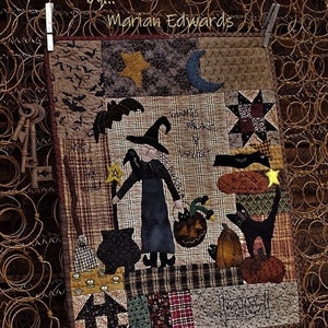 May include: A patchwork Halloween quilt with a witch, black cat, and pumpkins. The quilt uses various fabrics in black, brown, and orange. The text "Witchy Hollow" and "Marian Edwards" are visible. The quilt is hung with wooden pegs.