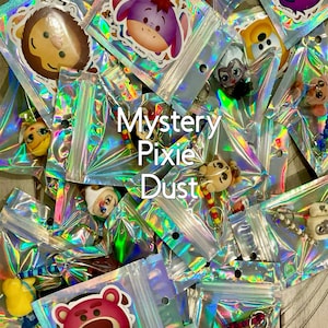 May include: A variety of colorful character charms in individual clear plastic bags with iridescent foil. The bags are labeled "Mystery Pixie Dust".