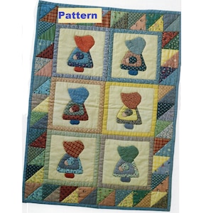 Op de afbeelding: Een quiltpatroon met het woord "Pattern" erop gedrukt. De quilt is gemaakt van verschillende kleurrijke stoffen en heeft een herhalend ontwerp van zes patchworkpoppen.