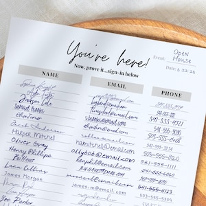 May include: A white sign-in sheet with the words "You're here!" in elegant script. It includes sections for name, email, and phone number, with handwritten entries. The event is labeled "Open House" with the date 6/22/25.